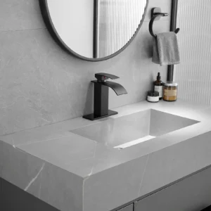 Black waterfall bathroom faucet installed on a gray bathroom vanity sink
