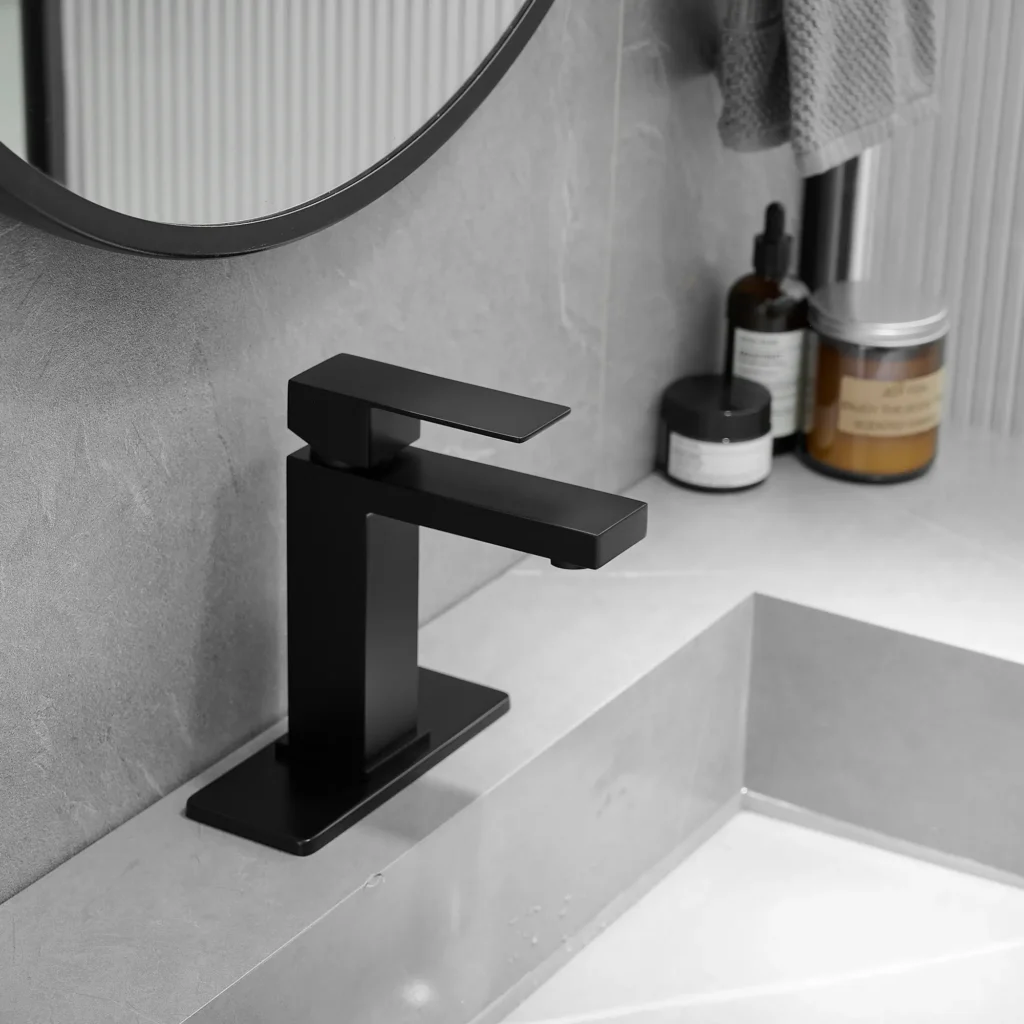 Black square bathroom faucet installed on a gray vanity sink