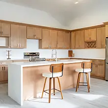 Shaker birch kitchen cabinets with white waterfall island